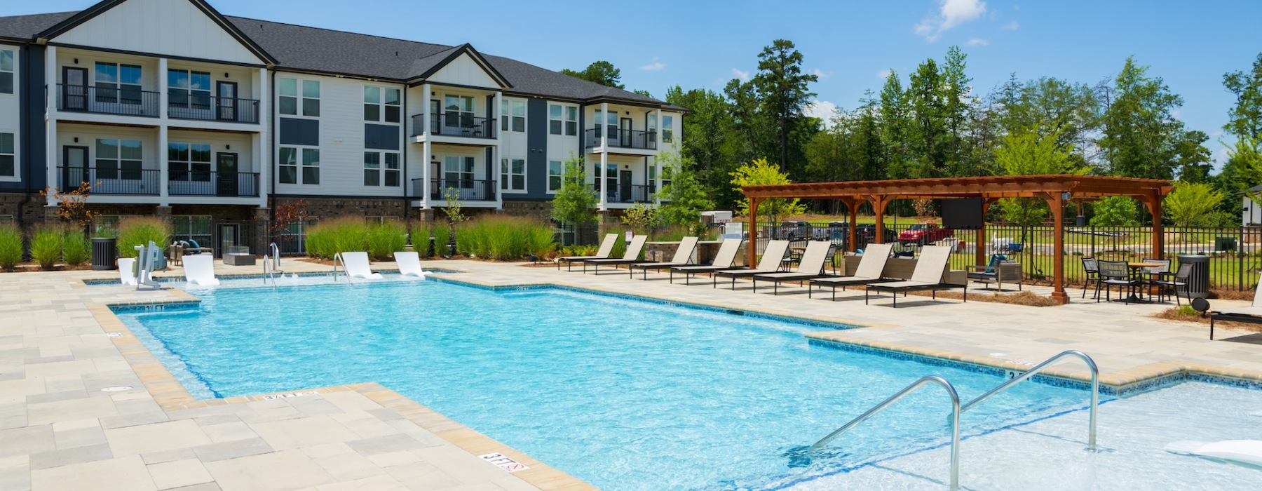 pool with spacious areas and lush landscaping