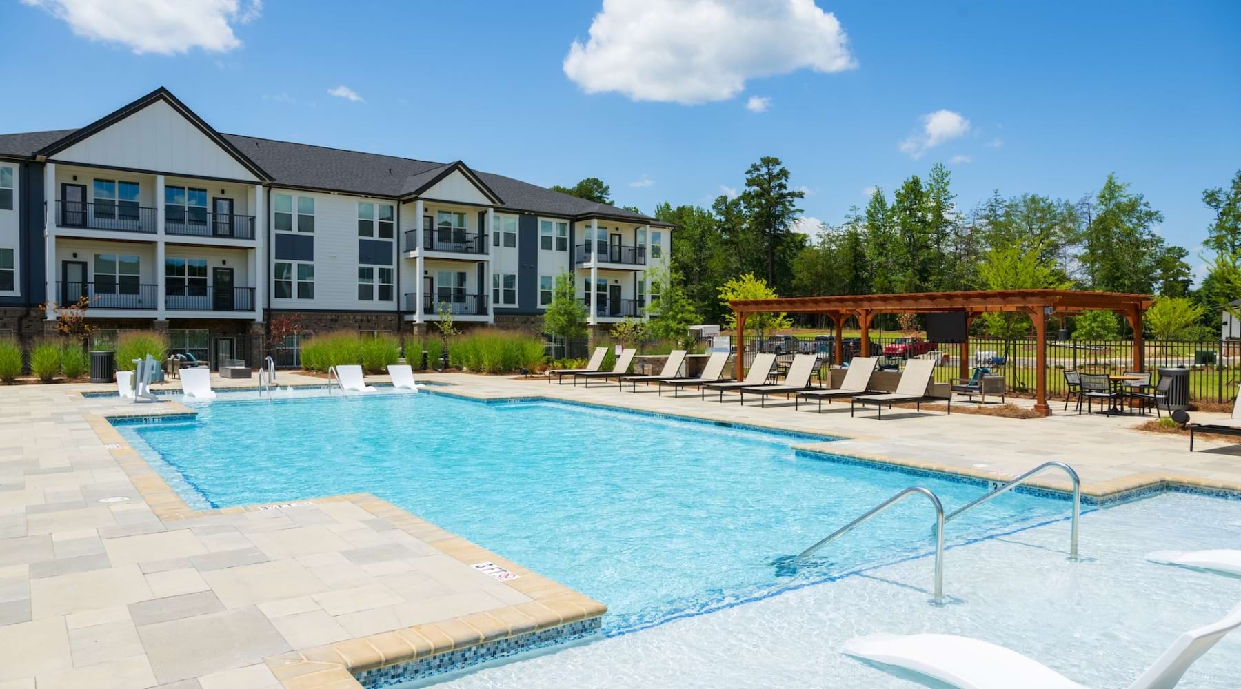 pool with spacious areas and lush landscaping